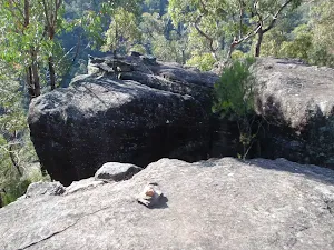Cairn on rock outcrop showing the route