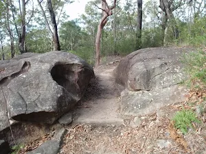 Walking between boulders towards Red Hands Cave