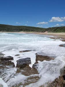 Crossing the rocks at the northern end of Frazer Beach