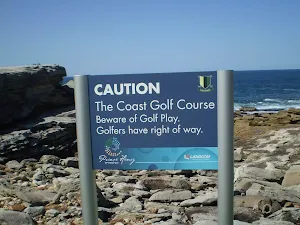 Caution sign about golf near Little Bay