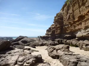 Sandy beach with rocks at Caves Beach Caves
