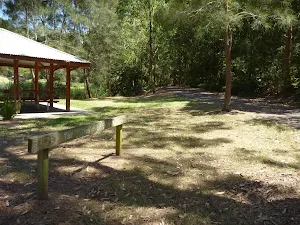 Sign and sheltered picnic tables in Richley Reserve