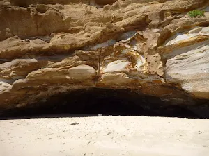 Large dark cave on Caves Beach