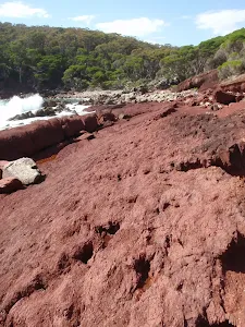 Red rock in red sands bay