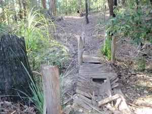 Old broken timber bridge on the track towards Abbotts Falls in the Watagans